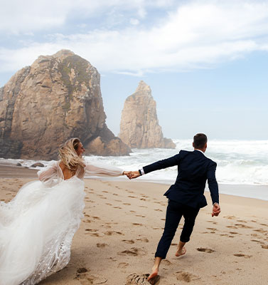 Wedding couple running in the beach